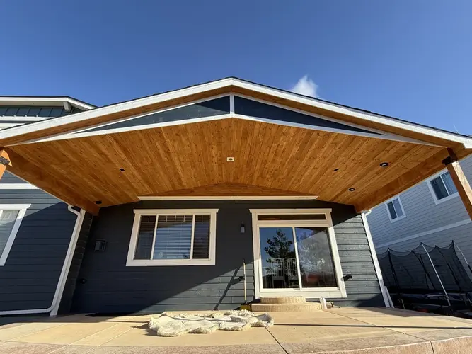 Elegant wooden patio cover installation over backyard deck area in Westminster residential property