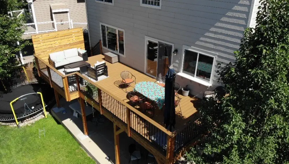 Spacious backyard deck in Arvada with seating and outdoor dining area